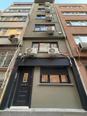 a tall building with windows and a door at Stylish 2BR in Central Istanbul 3-Min to Metro in Istanbul