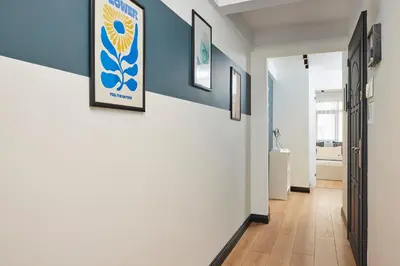 a hallway with blue and white walls and wooden floors at Superb Location 3 Min to Metro AC Elevator in Istanbul