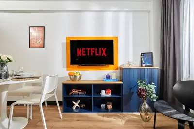 a living room with a blue cabinet with a netflix sign on it at Superb Location 3 Min to Metro AC Elevator in Istanbul