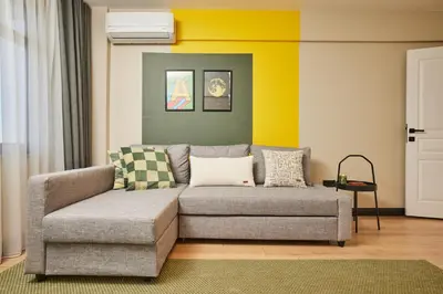 a living room with a couch and a chair at Heart of the City 3 Min to Metro 2BR AC in Istanbul