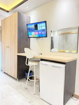 an office with a desk and a tv on the wall at The Blue Mansion Modern Rooms in Istanbul