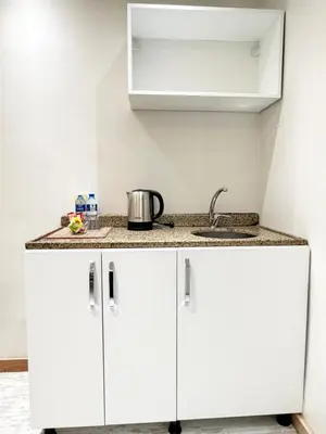 a kitchen with white cabinets and a sink at The Blue Mansion Modern Rooms in Istanbul