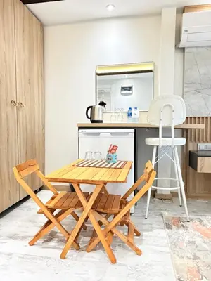 a kitchen with a wooden table and chairs at The Blue Mansion Modern Rooms in Istanbul