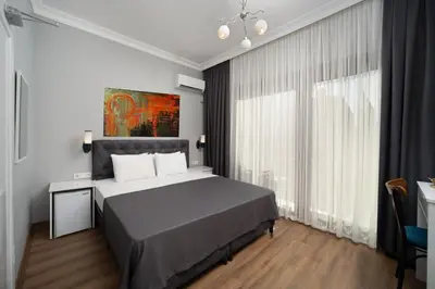 a bedroom with a bed and a large window at Sea Side Dream Apartment in Istanbul