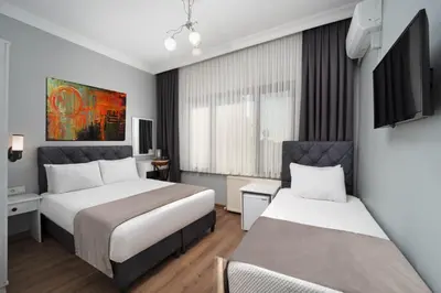 a hotel room with two beds and a tv at Sea Side Dream Apartment in Istanbul