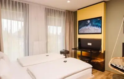 a hotel room with two beds and a laptop computer at White garden in Tuzla