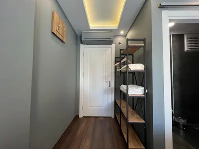 a room with a hallway with a door and shelves at KMC City Hotel in Lüleburgaz