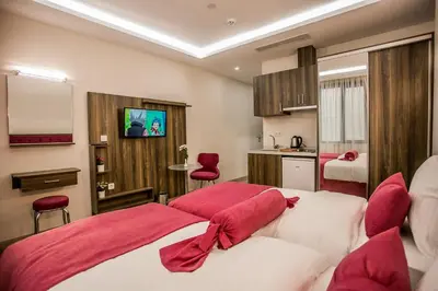 a bedroom with a large bed with red pillows at Babil Hotel in Istanbul