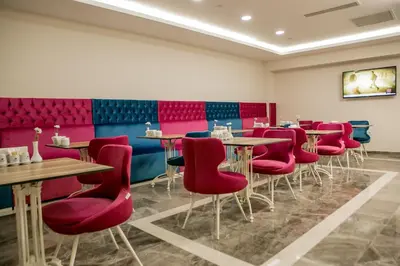 a dining room with tables and red chairs at Babil Hotel in Istanbul