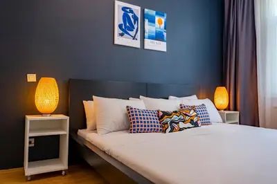 a bedroom with a bed with two lamps on it at 3-Bedroom 2-Bathroom, Centrally Located Ground-Floor Apartment -No Stairs in Istanbul