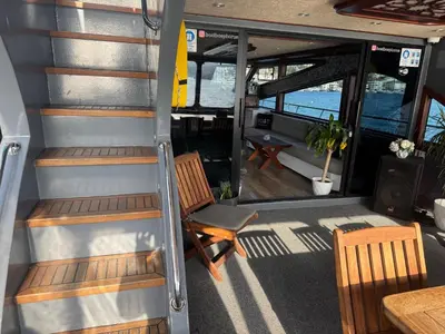 a staircase in a boat with two chairs and a table at Boat BOSPHORUS in Istanbul