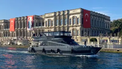 a boat in the water in front of a building at Boat BOSPHORUS in Istanbul