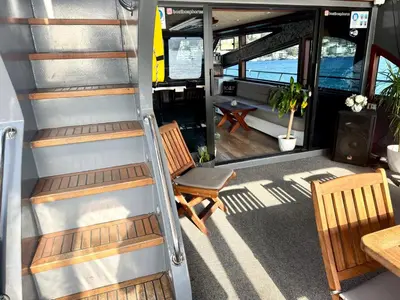 a staircase leading into a boat with two chairs and a table at Boat BOSPHORUS in Istanbul