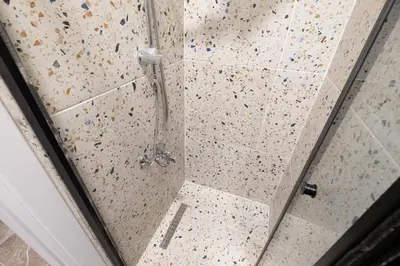 a shower with a glass door with a pole in it at Fully Renovated 2BR Flat in Center of Moda in Istanbul