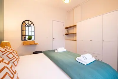 a bedroom with a bed with two towels on it at Fully Renovated 2BR Flat in Center of Moda in Istanbul