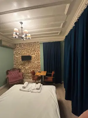 a bedroom with a bed and a table with chairs at Veva corner suit in Istanbul