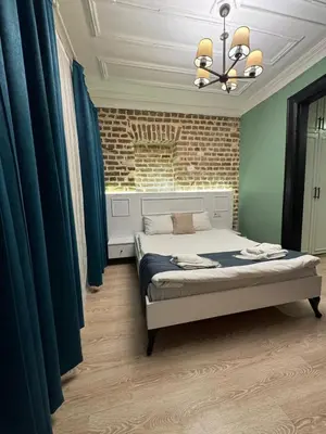 a bedroom with a bed in a room with blue drapes at Veva corner suit in Istanbul