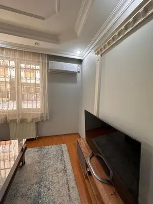 a living room with a couch and a window at Metroya 3 dakima uzaklıkta merkezi konumda in Istanbul