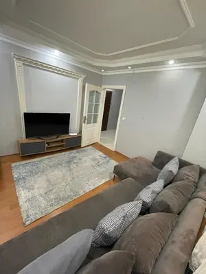 a living room with a couch and a flat screen tv at Metroya 3 dakima uzaklıkta merkezi konumda in Istanbul