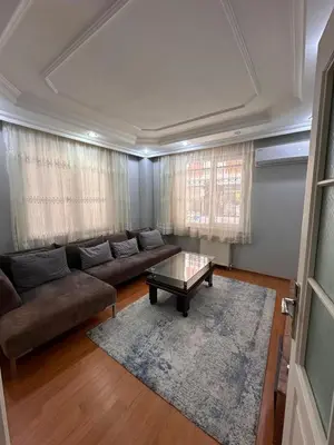 a living room with a couch and a coffee table at Metroya 3 dakima uzaklıkta merkezi konumda in Istanbul
