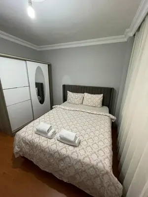 a bedroom with a bed with two towels on it at Metroya 3 dakima uzaklıkta merkezi konumda in Istanbul