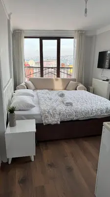 a bedroom with a large bed with a large window at Balat in Istanbul