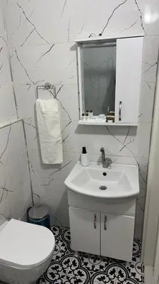 a white bathroom with a sink and a toilet at Balat in Istanbul