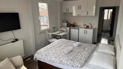 a small bedroom with a bed and a kitchen at Balat in Istanbul