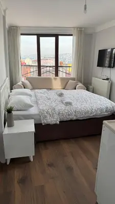 a bedroom with a large bed with a large window at Balat in Istanbul