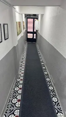 a hallway with a walkway with plates on the floor at Balat in Istanbul