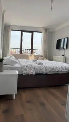 a large bed in a bedroom with a large window at Balat in Istanbul
