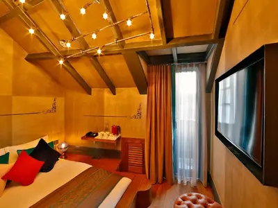 a bedroom with a bed and a tv in a room at Sanat Boutique Hotel Pera in Istanbul