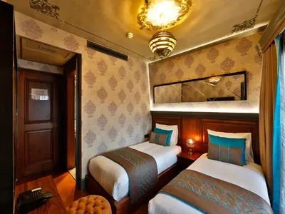 a room with two beds in a room with at Sanat Boutique Hotel Pera in Istanbul