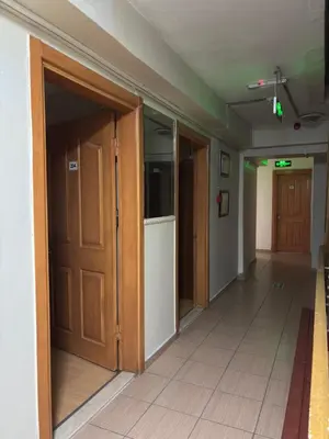 an empty hallway with wooden doors in a room at Huzur Otel Ümraniye in Istanbul