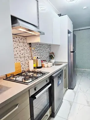a kitchen with a stove top oven next to a refrigerator at Excellent Apartments Fatih Citadel in Istanbul