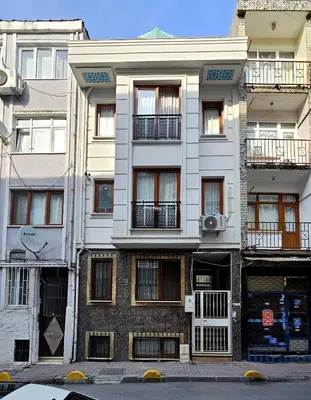 a tall white building with windows and balconies at Excellent Apartments Fatih Citadel in Istanbul