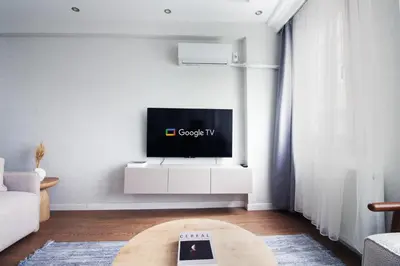a living room with a flat screen tv on a wall at Excellent Apartments Fatih Citadel in Istanbul