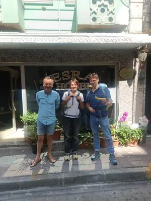 a group of three people standing in front of a store at İSTANBUL ESRA Hotel in Istanbul
