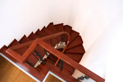 a wooden staircase in a room with white walls at Terrazzo Sapanca - Isıtmalı Havuzlu Villa Verde in Sapanca