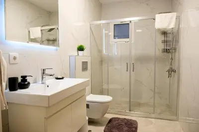 a bathroom with a shower and a sink and a toilet at Terrazzo Sapanca - Isıtmalı Havuzlu Villa Sole in Sapanca