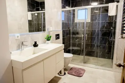 a bathroom with a sink and a toilet and a shower at Terrazzo Sapanca - Isıtmalı Havuzlu Villa Sole in Sapanca