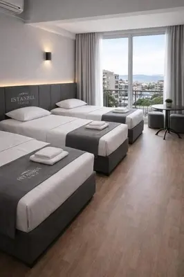a hotel room with four beds and a large window at İstanbul SİMGE hotel in Istanbul