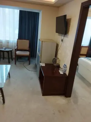 a living room with a couch and a tv in a hotel room at İstanbul SİMGE hotel in Istanbul