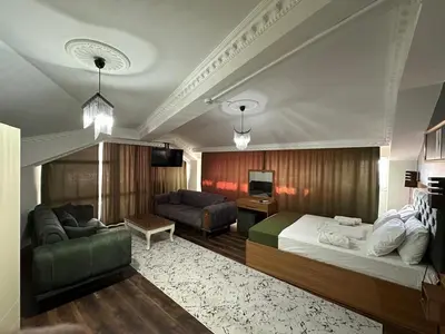 a hotel room with a bed and a couch at Riwaner Hotel in Avcılar