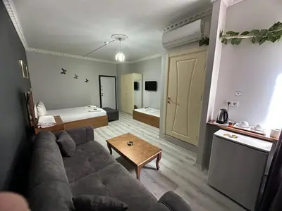 a living room with a couch and a table at Riwaner Hotel in Avcılar