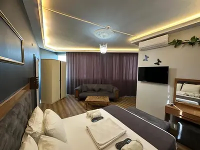 a hotel room with a bed and a couch at Riwaner Hotel in Avcılar
