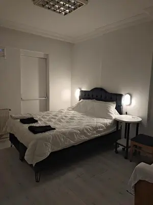 a bedroom with a large bed and a table at Üsküdar sahil otel in Istanbul