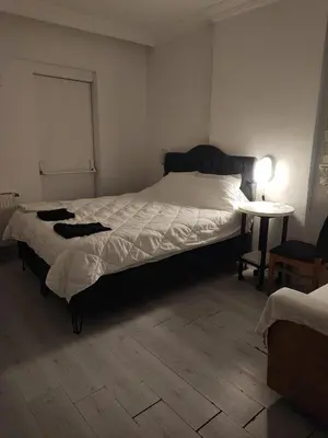 a bedroom with a large bed and a table at Üsküdar sahil otel in Istanbul