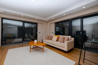 a living room with a couch and a table at Sea View Two-Bedroom Suite in Managed Residence - Parking and Elevator in Istanbul