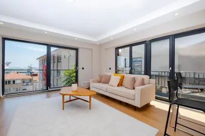 a living room with a couch and a table at Sea View Two-Bedroom Suite in Managed Residence - Parking and Elevator in Istanbul